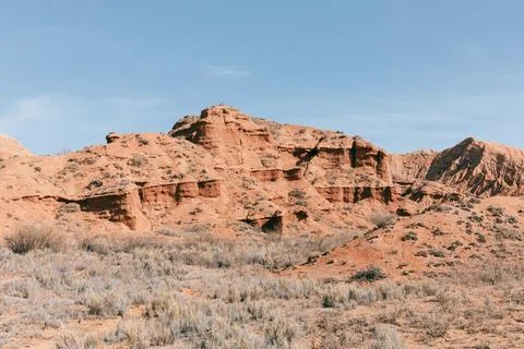 Mars Canyon red sandstone cliffs and semi desert landscape in Kyrgyzstan Stock Photos