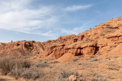 Mars Canyon red sandstone cliffs and arid desert landscape under blue sky Stock Photos