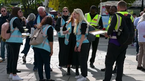 Marshals preparing to hand out wrist bands to people waiting in the queue to Stock Footage 211819662