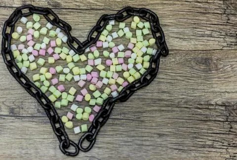 Marshmallow balls inside the shape of heart chain. Stock Photos