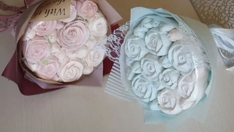Marshmallow bouquets in craft packaging. Consist of zephyr roses and tulips.  Stock Footage 159348753
