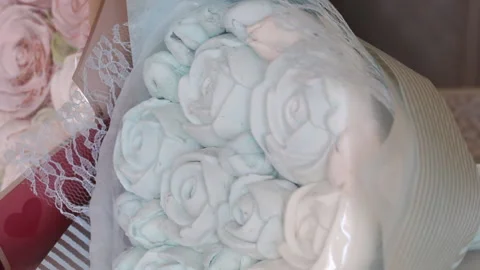 Marshmallow bouquets in craft packaging. Consist of marshmallow roses and tul Stock Footage 159349062