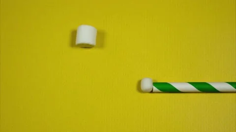 Marshmallow bubbles are blown out of a paper straw. Stop motion Stock Footage 169969927