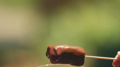 Marshmallow dipped into melted chocolate Stock Footage 274630131