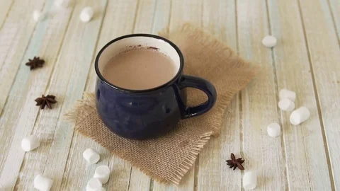 Marshmallow falls into a cup of cocoa and drops on the table Stock Footage 82711033