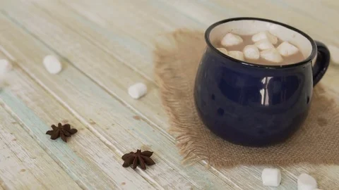Marshmallow falls into a cup of cocoa and drops on the table Stock Footage 82948613