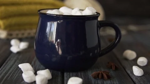 Marshmallow falls into a cup of cocoa and drops on the table Stock Footage 83230016