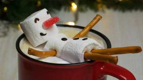 Marshmallow snowman basking in a coffee mug Stock Footage 144398135
