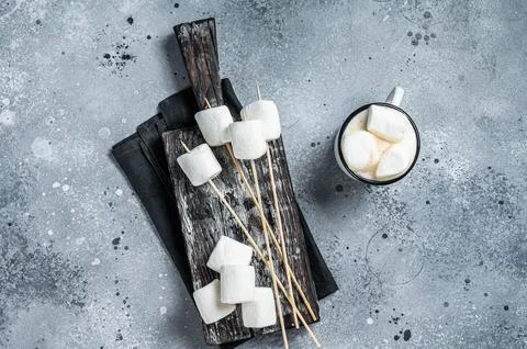 Marshmallow on the stick ready for BBQ. Gray background. Top view Stock Photos