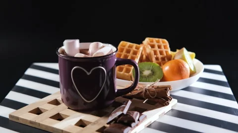 Marshmallows added to hot chocolate on breakfast Stock Footage 296215740