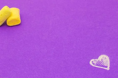 Marshmallows and heart on violet background Stock Photos