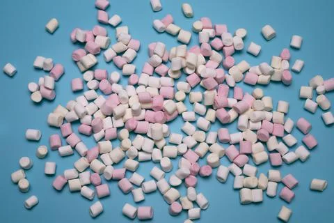 Marshmallows on the blue background, flat lay. Stock Photos