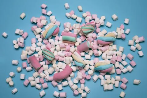 Marshmallows on the blue background, flat lay. Stock Photos