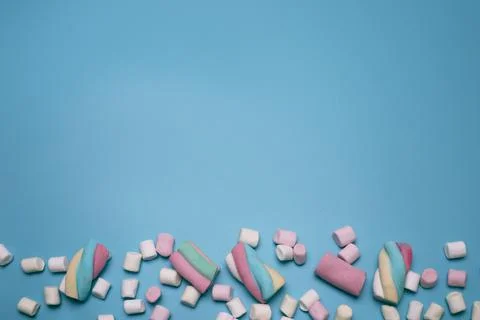 Marshmallows on the blue background, with free space for text. Stock Photos