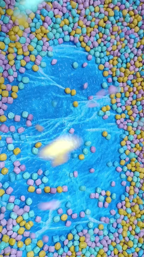 Marshmallows in a blue lagoon, perfect for summerthemed designs, sweet treat adv Stock Footage 335077582