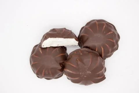Marshmallows in chocolate. The isolated image on the white background. Stock Photos