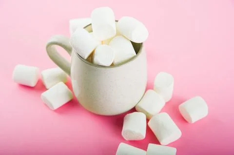 Marshmallows close-up and copy space on a pink background. Marshmallows in an ea Stock Photos