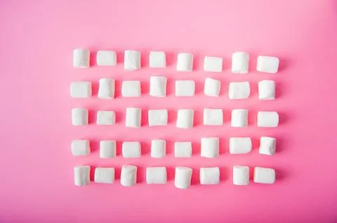 Marshmallows close-up and copy space on a pink background.  Stock Photos