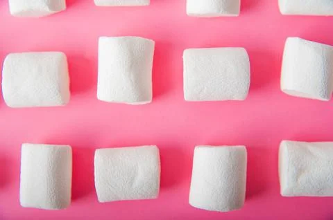 Marshmallows close-up and copy space on a pink background.  Stock Photos