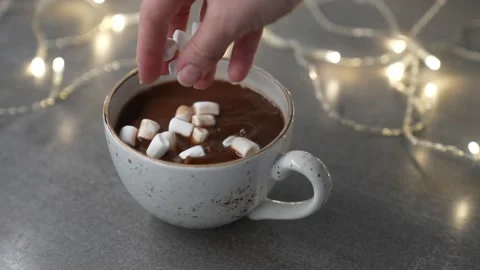 Marshmallows dropping cup with delicious hot chocolate cocoa drink. Stock Footage 231795045