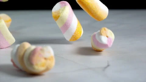 Marshmallows falling on a pastel background . Super slow motion 1000 fps Stock Footage 323380296