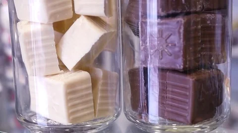 Marshmallows in a glass jar on a white cloth. Closeup. The Bank is decorated Stock Footage 85123353