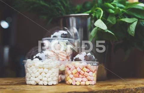 Marshmallows in glass jars on bar for sale Stock Photos