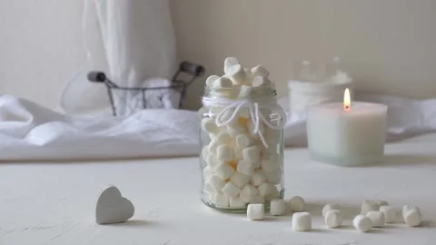 Marshmallows in a glass on a white table Stock Footage 148274445