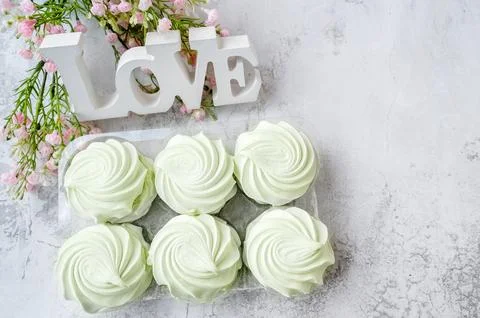 Marshmallows. Green zephyrs as a serving on the table. Close-up of a sweet .. Stock Photos