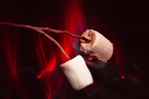 Marshmallows over a campfire close up Stock Photos