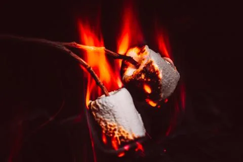 Marshmallows over a campfire close up Stock Photos