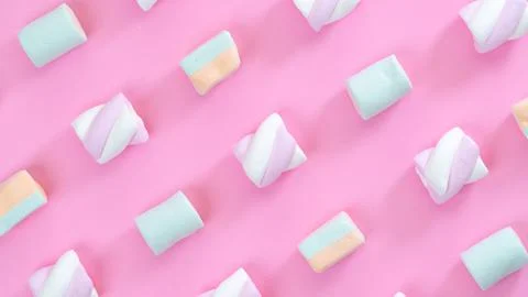 Marshmallows on pink background diagonal lines close-up, multi-colored sweets Stock Photos