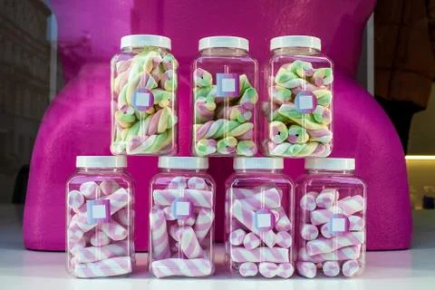 Marshmallows in plastic jars in candy store window 스톡 사진