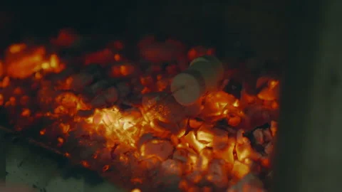 Marshmallows roasting over glowing hot coals on an outdoor BBQ, capturing the Stock Footage 345806310