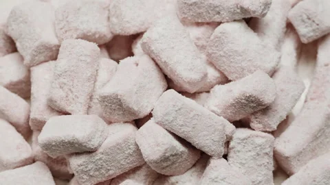 Marshmallows rotating close-up macro. Dry fruits in powdered sugar. Sweets and Stock Footage 260980643