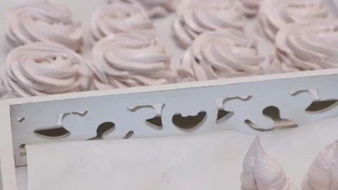 Marshmallows of various shapes and sizes lie on a tray, laid out for stabiliz Stock Footage 163651835