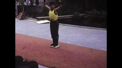 Martial artist performing knife throwing tricks on eggs in hong kong, 1985 Stock Footage 297878342