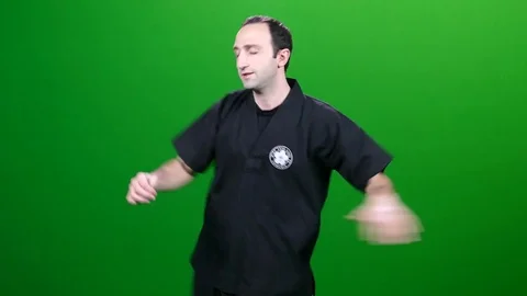 Martial Arts doing High Kick Stretches on Green Screen Stock-Footage 83735225