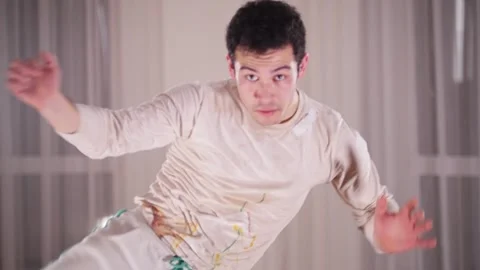 Martial arts. A professional man performing an acrobatic capoeira elements Stock Footage 325345514