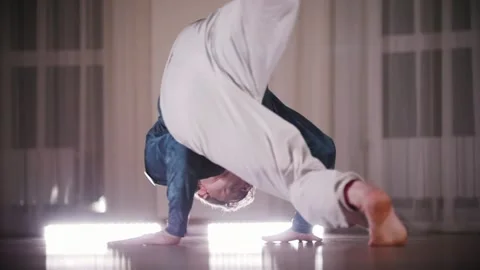 Martial arts. A professional man performing an acrobatic capoeira elements Stock Footage 325345868