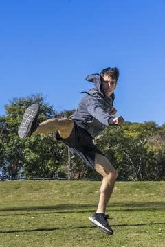Martial fighter practicing flying kicks. Copy space Stock Photos