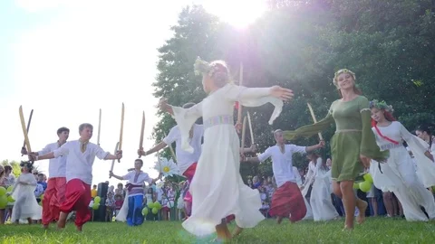 Martial national dances at holiday ivana kupala on nature, boys and girls Stock Footage