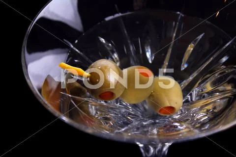 Martini with olives on black Stock Photos