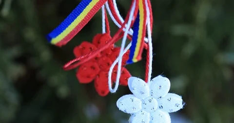 Martisor is a red and white string and which is offered by people on March 1 Stock Footage 103481325