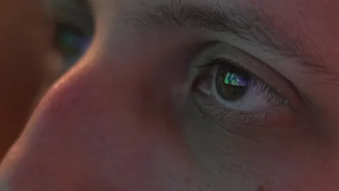 The Marvel Logo Intro on the Television was Reflected in the Man's Eyes - Stock Footage 277675576