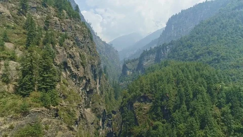 Marvelous narrow gorge between towering forested cliffs, Nepal Stock Footage 124678581