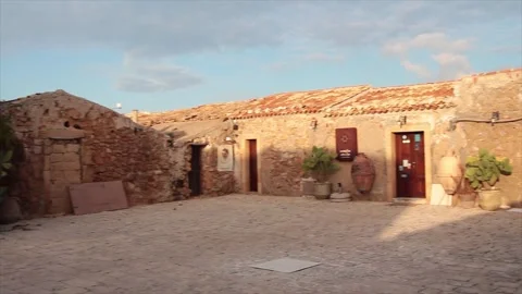 Marzamemi sicily italy empty courtyard pan right to left Stock Footage 252153134