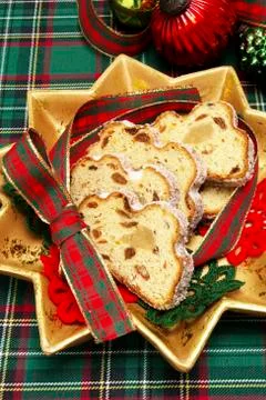 Marzipan stollen, cut up on a star-shaped plate Stock Photos