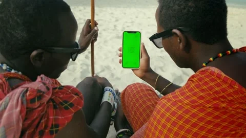 Masai Tribe Men Looking at the Smartphone and Touching Green Screen in the Front Stock Footage 188951745