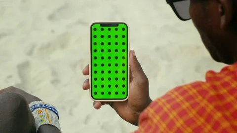 Masai Tribe Men Looking at the Smartphone and Touching Green Screen in the Front Stock Footage 199983996